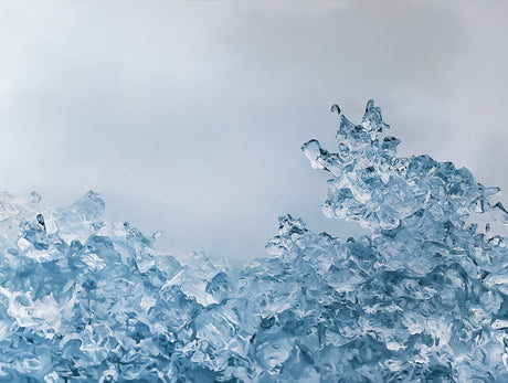 FELLSFJARA, ICELAND NO 12: This image showcases a close-up view of blue ice formations in a frozen landscape. The intricate, jagged shapes of the ice create a mesmerizing abstract pattern. The icy surface reflects the light, adding to the ethereal beauty of the scene. The image evokes a sense of tranquility and the power of nature.