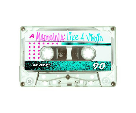 LIKE A VIRGIN: Like A Virgin written in pink and teal lettering on the label. The cassette tape is white with a pink and teal design and the number 90 printed on it. The tape is likely from the 1980s or 1990s.