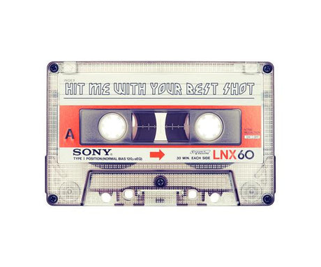 HIT ME WITH YOUR BEST SHOT: A close-up image of a vintage audio cassette tape with a label reading Hit Me With Your Best Shot. The cassette is clear plastic with a white label, red and blue accents, and a Sony logo. The tape is likely from the 1980s or 1990s.