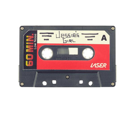 JESSIE'S GIRL: This is a black cassette tape with a red label. The label says Jessies Girl and 90 MIN in white text. The tape is labeled as Laser and Low Noise. This image was likely taken in the 1980s or 1990s.