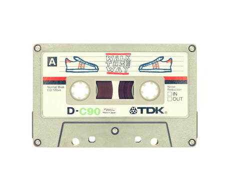 WALK THIS WAY: A vintage TDK D-C90 audio cassette featuring a hand-drawn design of a sneaker on each side with the text Walk This Way written in black marker. The cassette is made in Japan and has a normal bias EQ of 120 Î¼s. The noise reduction feature is set to out.