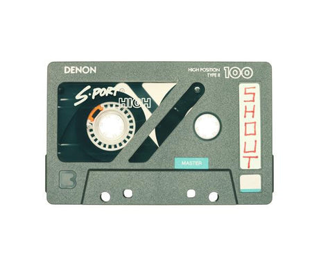 SHOUT: A close-up shot of a Denon S-Port high position Type II 100 cassette tape. The label features the word Shout in red lettering. The cassette tape is a vintage music recording medium.