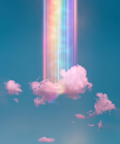 SELF MEDICATE: A vibrant rainbow, rendered in bright, vertical streaks of light, illuminates a fluffy, pink cloud in a clear blue sky. Several other clouds drift through the background, adding to the ethereal beauty of the scene. The colors are soft and inviting, creating a sense of calm and wonder.