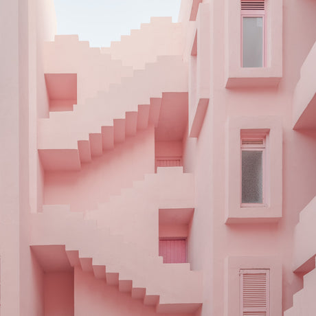 PINK STAIRS: A pink building with a unique staircase design, featuring multiple windows and a contrasting white sky. The bright color and architectural details create a visually appealing and modern aesthetic.