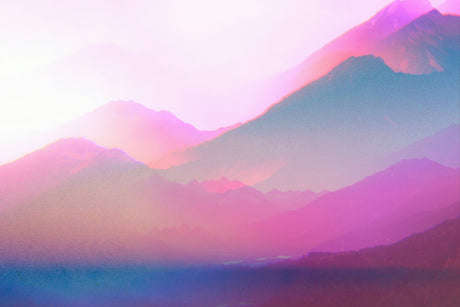 DISSOLUTION III: A soft, dreamy image of a mountain range shrouded in morning fog. The mountains are a blend of pink, blue, and purple hues, with the sunlight shining through the mist. The image evokes a sense of peace and tranquility.