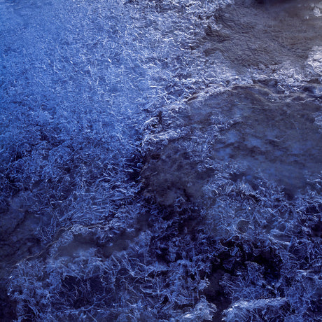 STUDY I: An abstract close-up of a frozen lake surface showing intricate patterns of ice formations in shades of blue, giving an almost crystal-like appearance to the image.