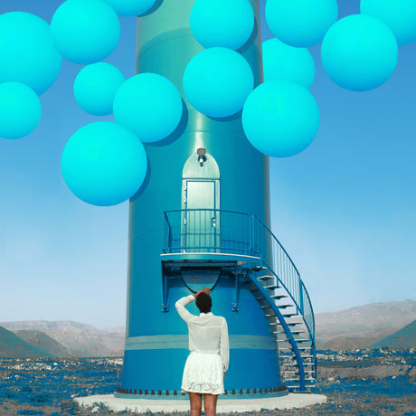 THE MEETING POINT: A woman in a white dress stands near a large, blue wind turbine, her gaze directed upwards toward a cluster of bright blue balloons floating in the air. The wind turbine is in a desert landscape, with brown, rocky mountains in the background. The overall scene creates a sense of wonder and possibility.