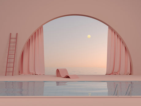 OVER THE MOON: This image showcases a minimalist pool with a pink and blue color scheme. The pool is surrounded by a pink floor and walls, with a large archway framing a view of the ocean. Pink curtains hang on either side of the archway, and a single, wooden lounge chair rests beside the pool. A ladder leans against the wall, suggesting a connection to the pool. The image captures a serene and peaceful atmosphere, with the soft colors and minimalist design creating a calming ambiance.