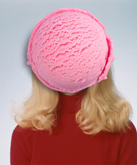 PORCA MISERIA: A woman with long blonde hair wears a red turtleneck sweater, with a giant pink ice cream cone covering her face. This photo is a playful and whimsical portrait of a person with an interesting hat.