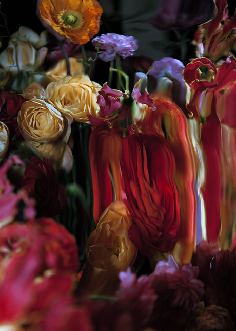 LIQUID MIRRORS 8: A close-up view of a bouquet of flowers with a variety of red, orange, and yellow flowers. The flowers are arranged in a vase and are in a dark setting. The image is taken from a low angle, and the flowers are in focus.