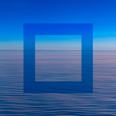 SEA OF CLOUDS: This image shows a bright blue square superimposed over a calm, still sea at dawn. The square appears to be floating just above the surface of the water, creating a minimalist and abstract composition. The colors in the image are muted and soft, reflecting the early morning light.