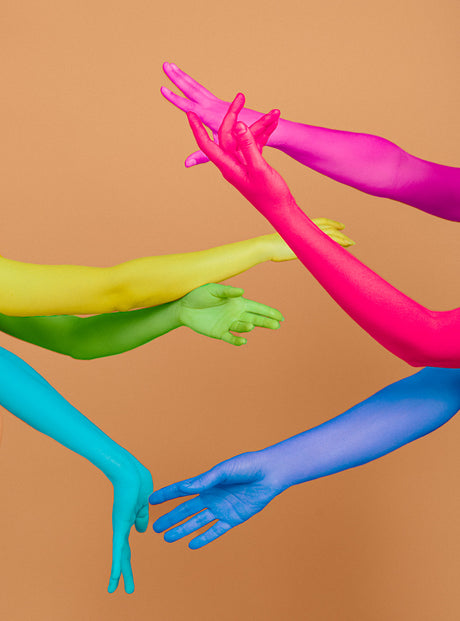 WAVY II: pink, green, yellow, and blue. The image creates a sense of movement and connection. The hands seem to be reaching towards something, perhaps a common goal or a shared dream.