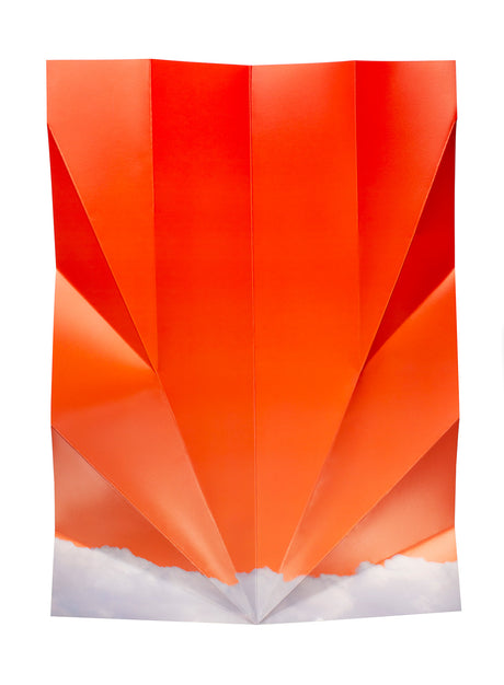 OCTOBER: This image features a sheet of orange paper folded into a geometric shape with a white cloud base. The paper is folded in a way that creates a series of sharp angles and points, which gives the shape a modern and abstract look. The white cloud base provides a contrasting element and adds a sense of depth to the image.