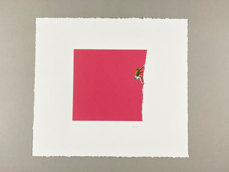 climb ON: A climber wearing green and white clothing scales a large, torn, red paper wall. The climbers arms are outstretched as he pulls himself up the wall. The paper is torn on the right side, revealing a white background.