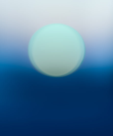 ENDLESS SUMMER NO6: A single, large, round, out-of-focus light orb is floating in the center of the image. The orb appears to be emitting a soft, white light. The background is a gradient of white fading to light blue at the top and dark blue at the bottom.