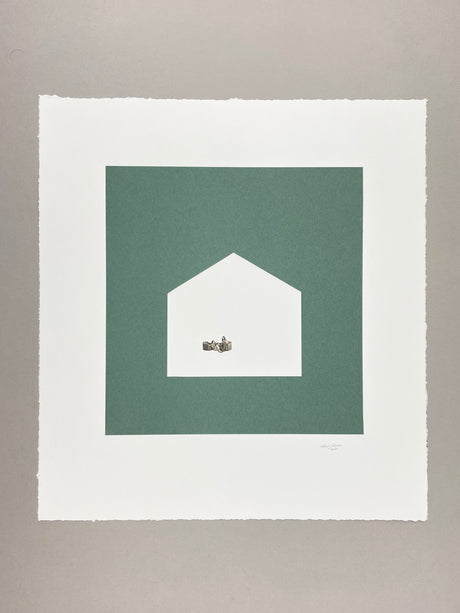 minimalist LIVING: This abstract art piece features a geometric shape cut out from a green background. Inside the cutout, a silver object sits on a white surface. The minimalist design and limited color palette create a sense of calm and simplicity.